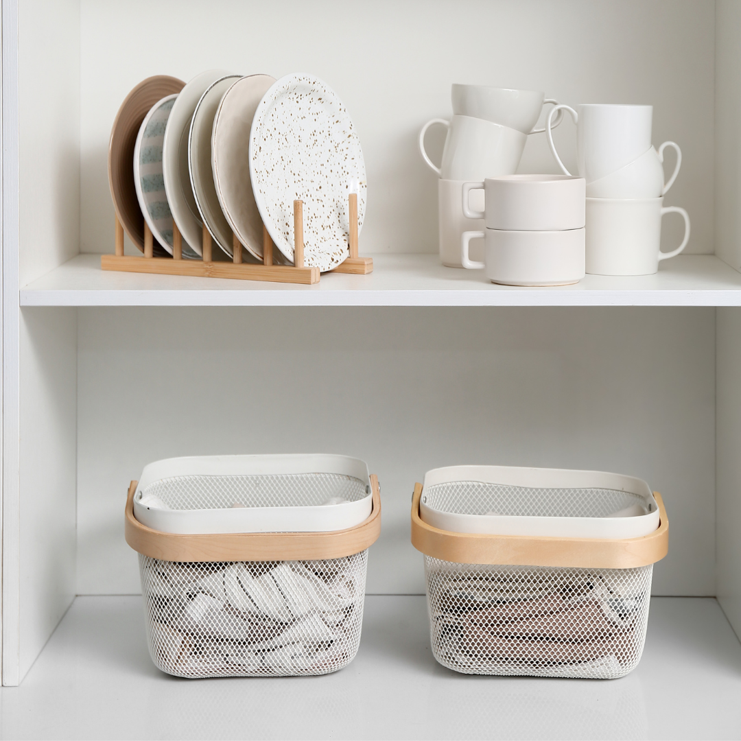 Open kitchen cabinet showing organised zones — the goal of kitchen cabinet organisation