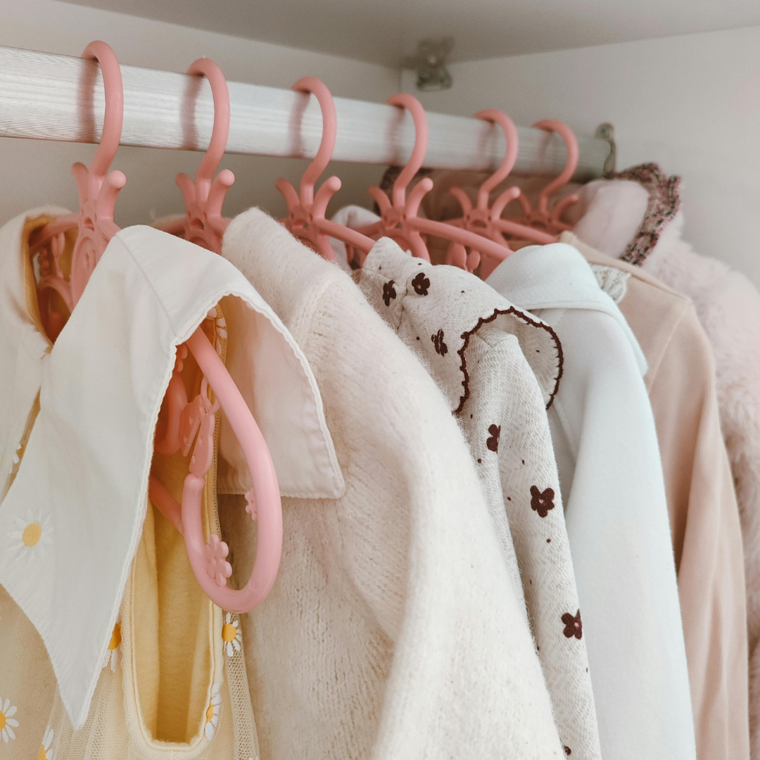 A tidy kids wardrobe with a designated donate basket underneath