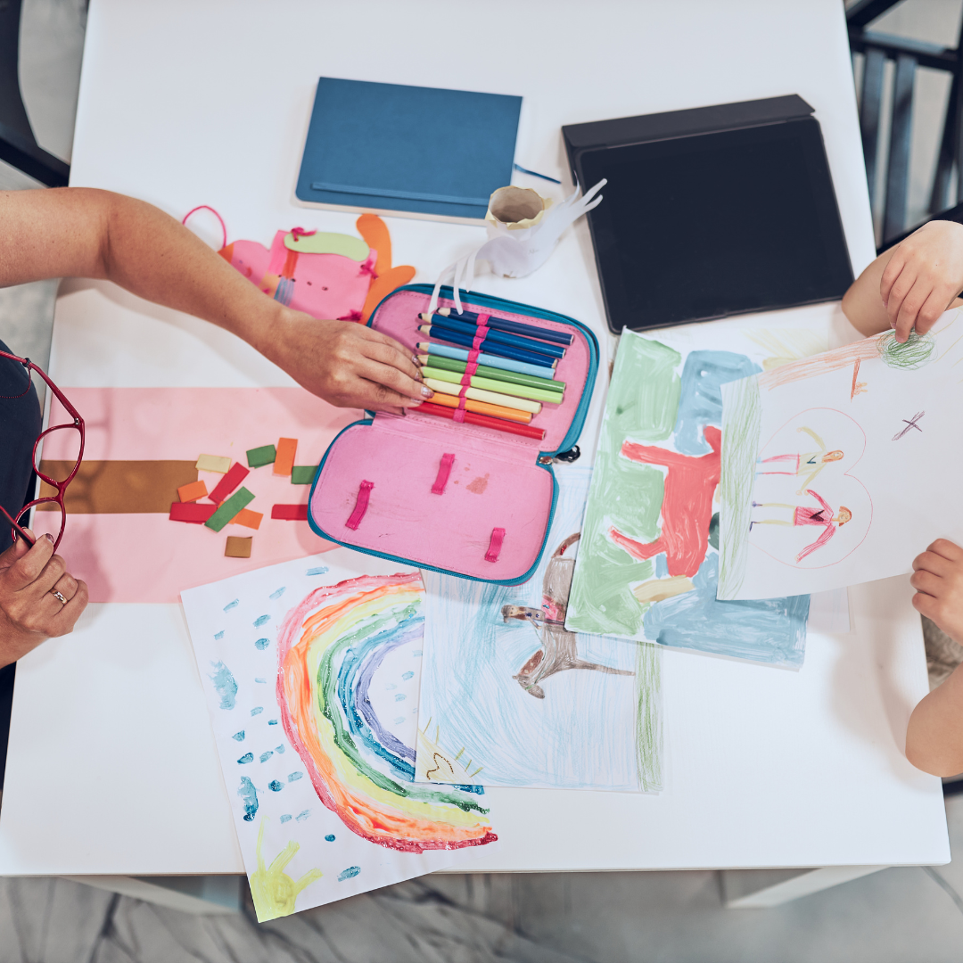 Labelled keepsake box holding a handful of saved kids artwork