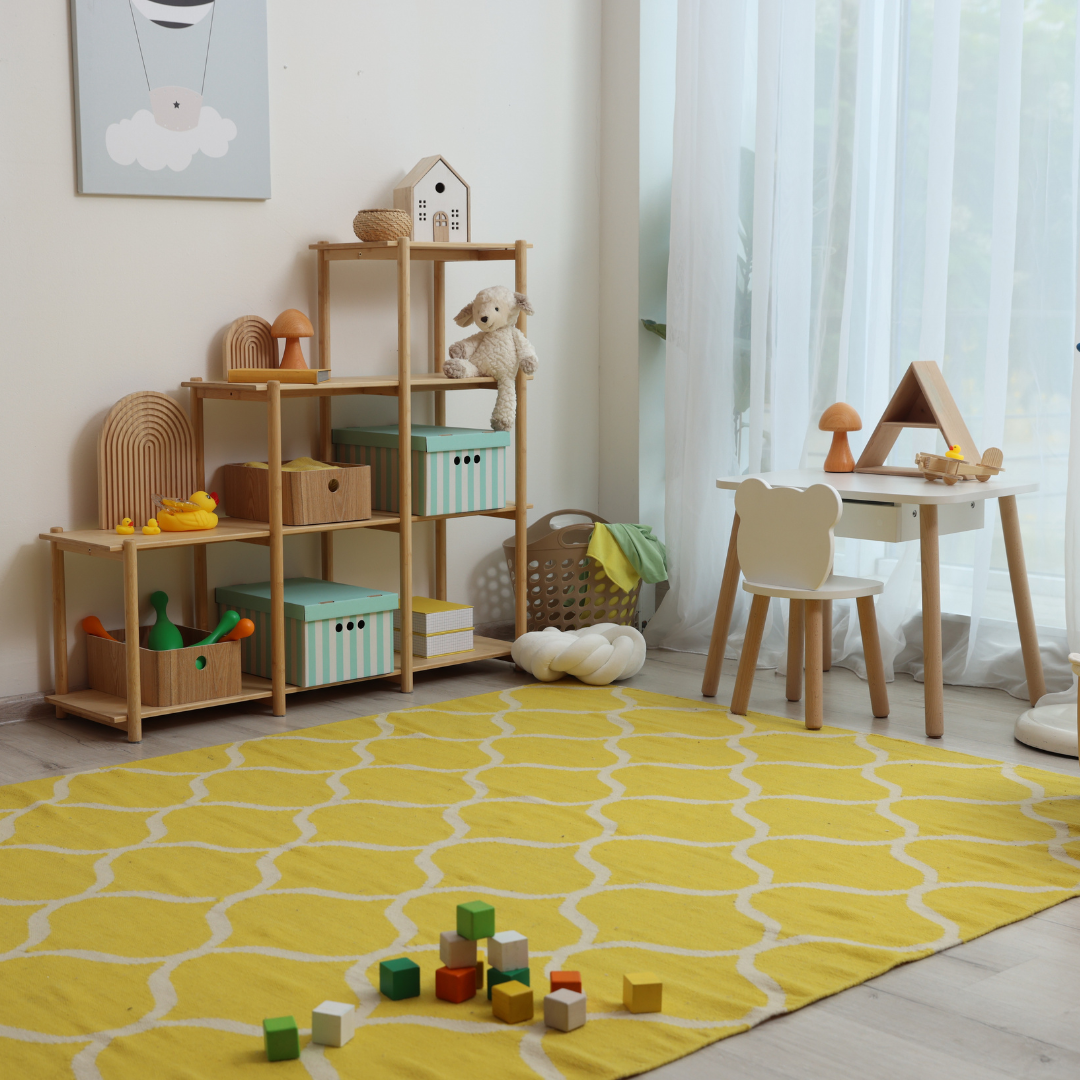 Clear play area shelf with a few toys on display and labelled bins stored above
